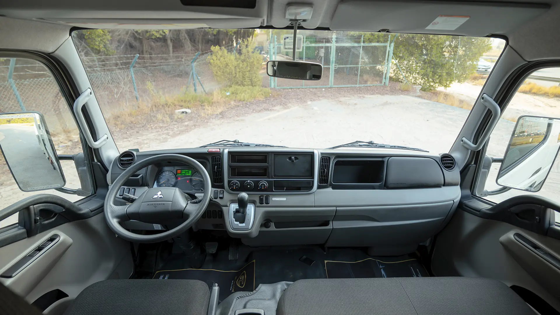 Used 2024 Mitsubishi Canter Double Cabin Cargo Body in White – Front Cabin / Dashboard Full View for Sale at First Choice Cars Dubai Sharjah