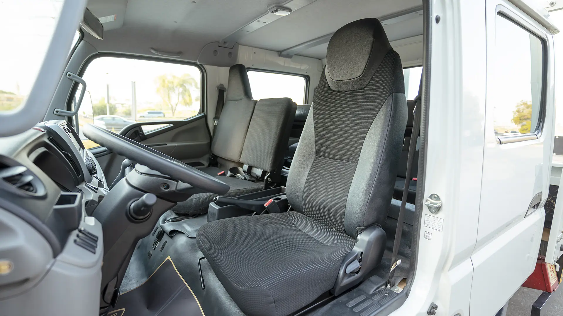 Used 2024 Mitsubishi Canter Double Cabin Cargo Body in White – Front Driver Side Cabin View for Sale at First Choice Cars Dubai Sharjah