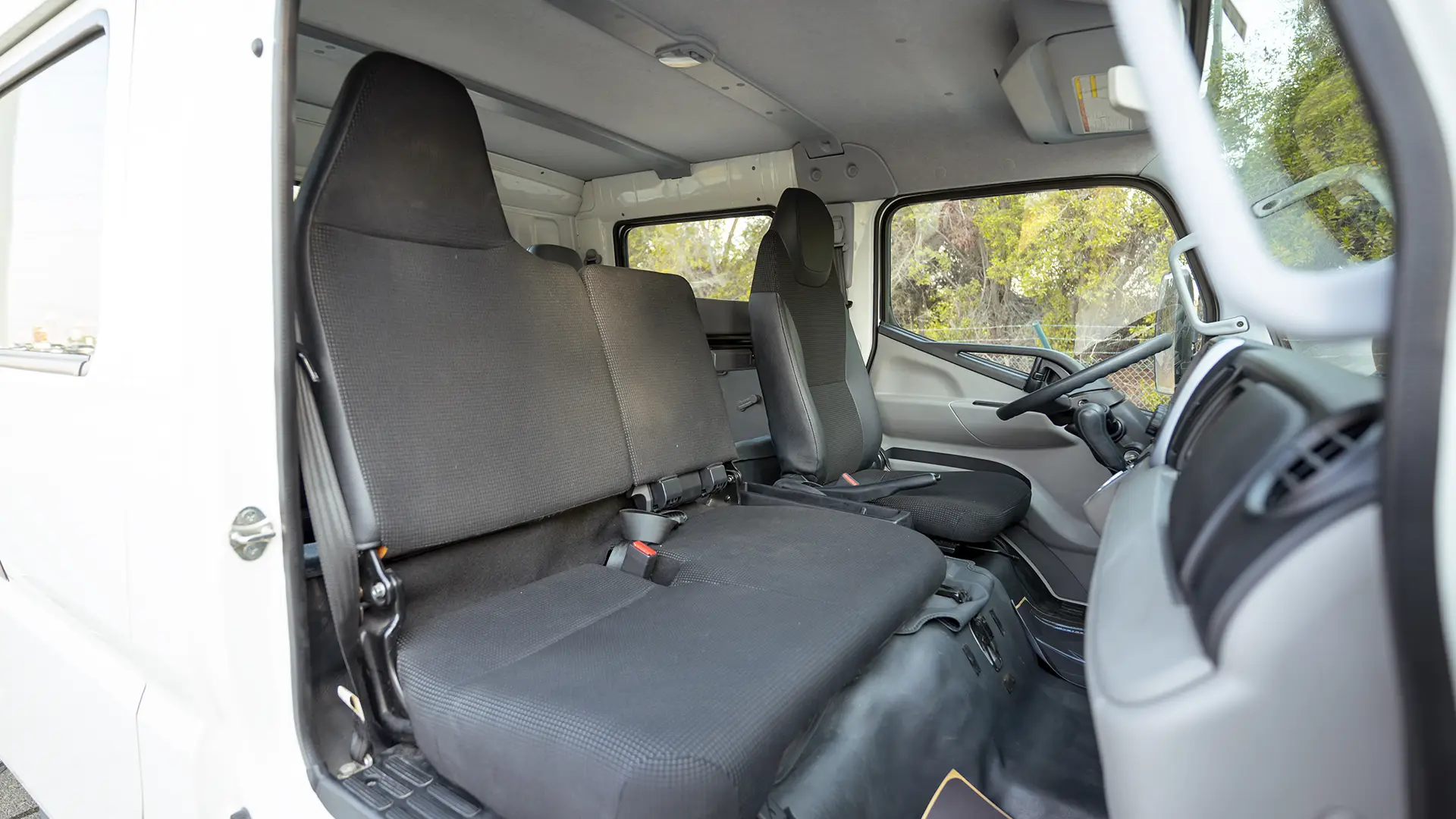 Used 2024 Mitsubishi Canter Double Cabin Cargo Body in White – Front Passenger Side Cabin View for Sale at First Choice Cars Dubai Sharjah