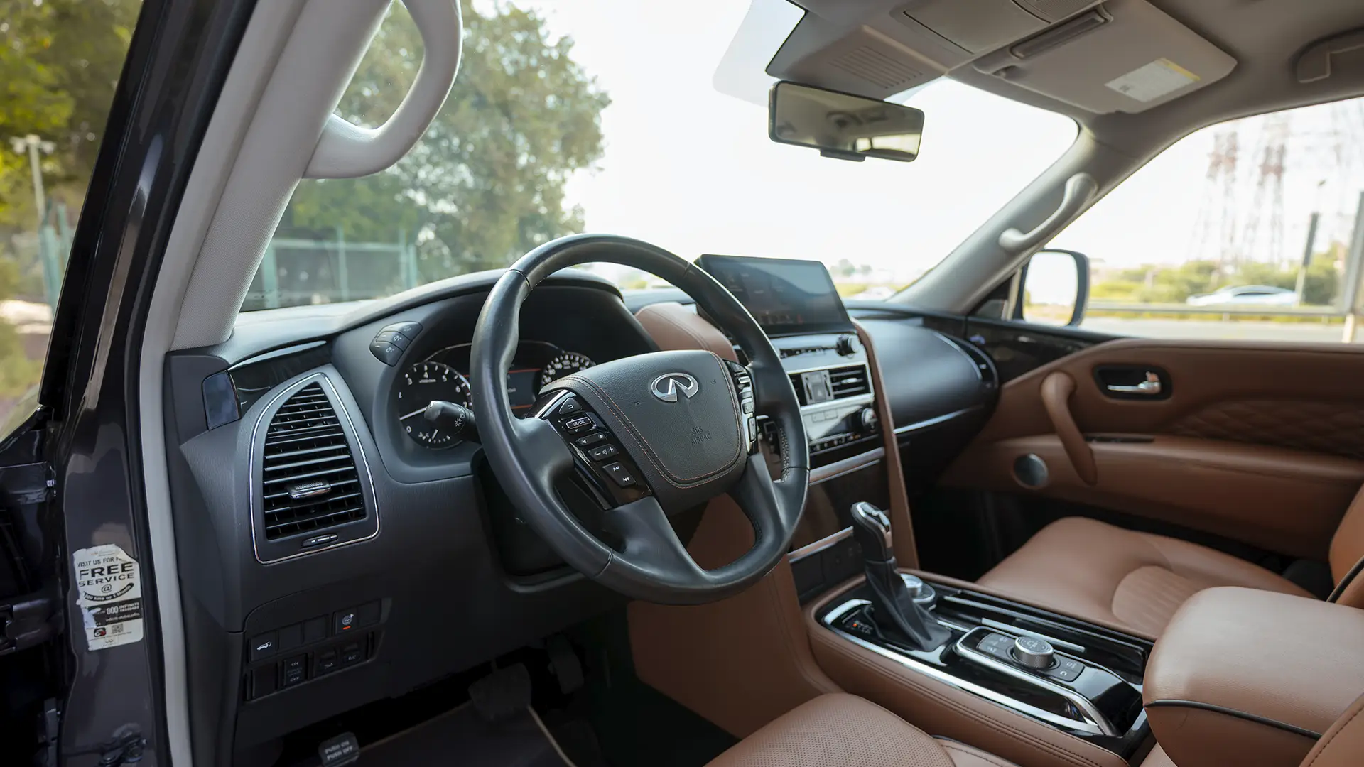 Used 2023 Infiniti QX80 Sensory in Grey – Driver Side Dashboard & Steering View for Sale at First Choice Cars Dubai Sharjah