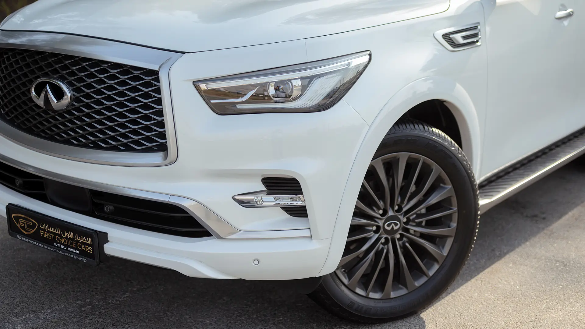 Used 2023 Infiniti QX80 Sensory in White – Headlight Close-up for Sale at First Choice Cars Dubai Sharjah