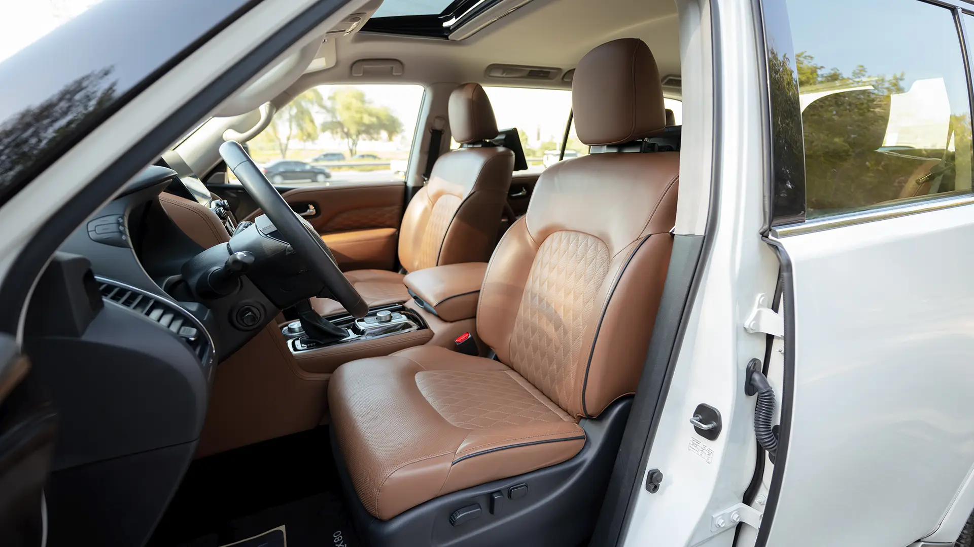 Used 2023 Infiniti QX80 Sensory in White – Front Driver Side Cabin View for Sale at First Choice Cars Dubai Sharjah
