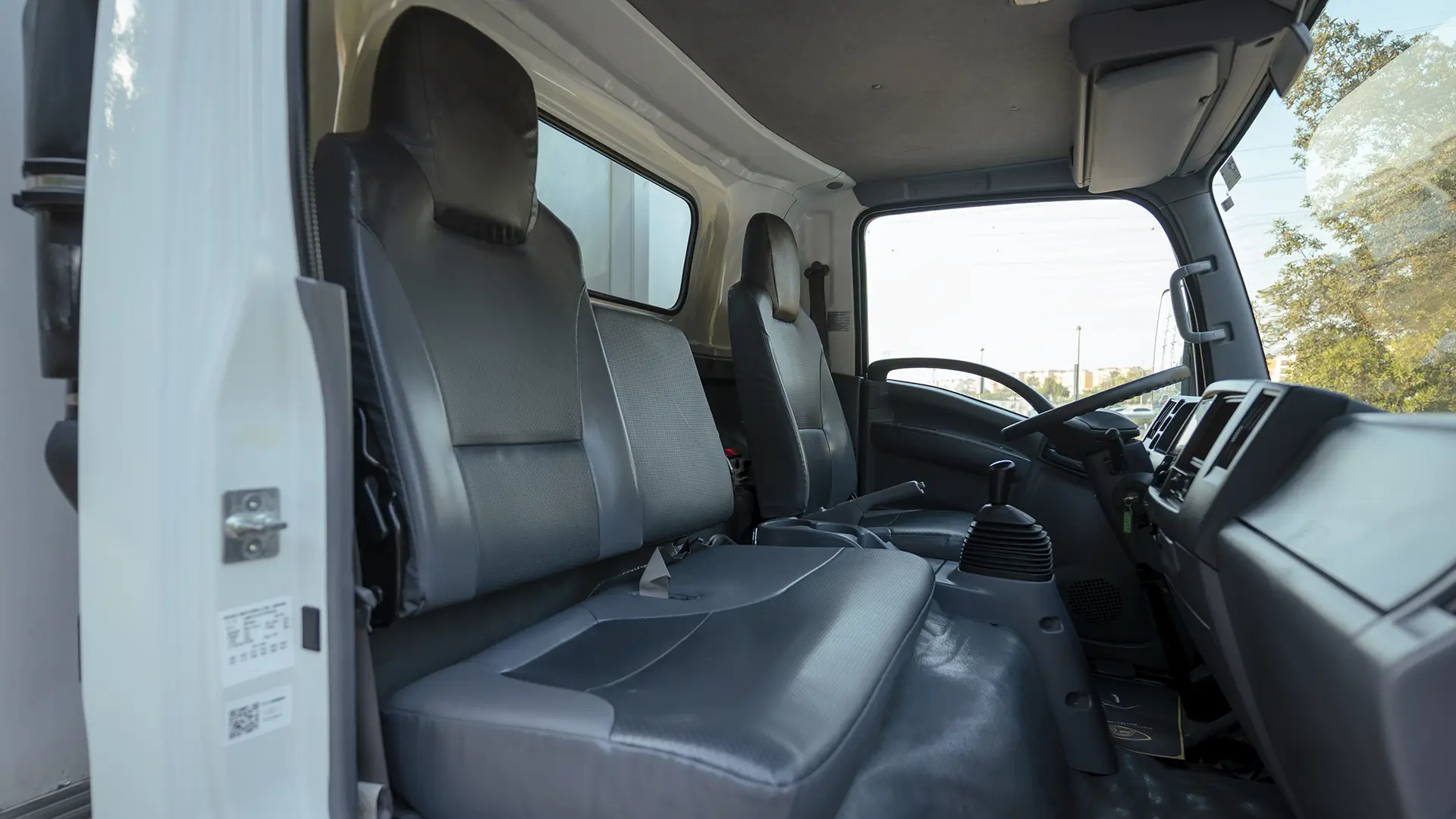Used 2023 Isuzu Reward Chiller in White – Front Passenger Side Cabin View for Sale at First Choice Cars Dubai Sharjah