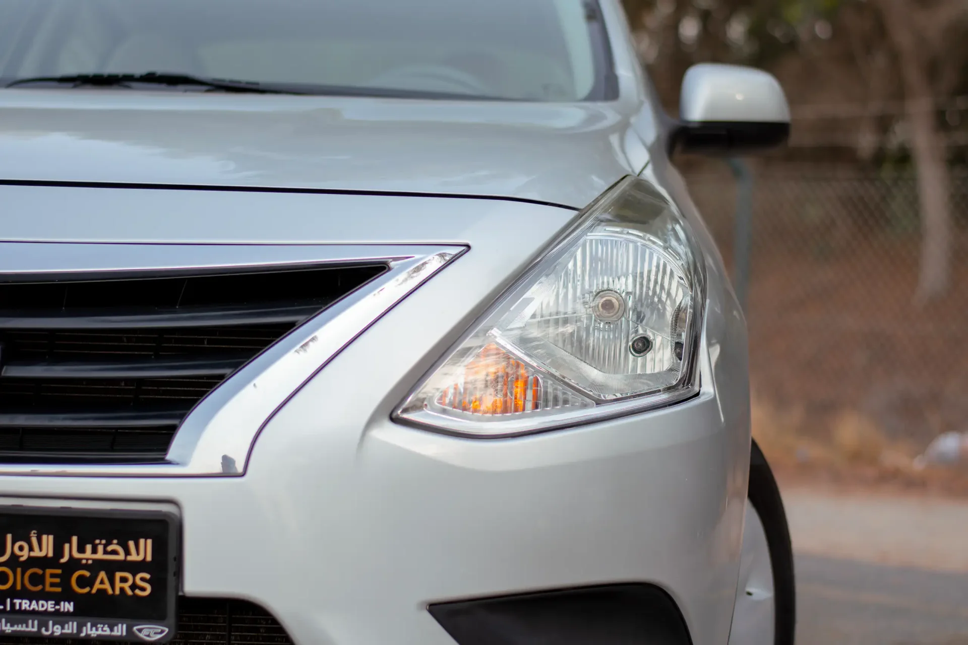 Used 2023 Nissan Sunny SV in Silver – Headlight Close-up for Sale at First Choice Cars Dubai Sharjah