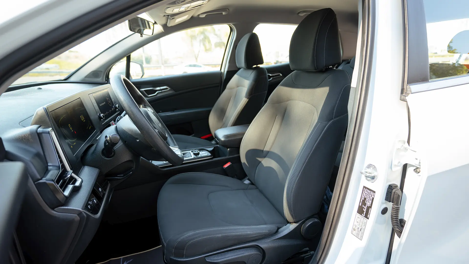 Used 2023 Kia Sportage EX in White – Front Driver Side Cabin View for Sale at First Choice Cars Dubai Sharjah
