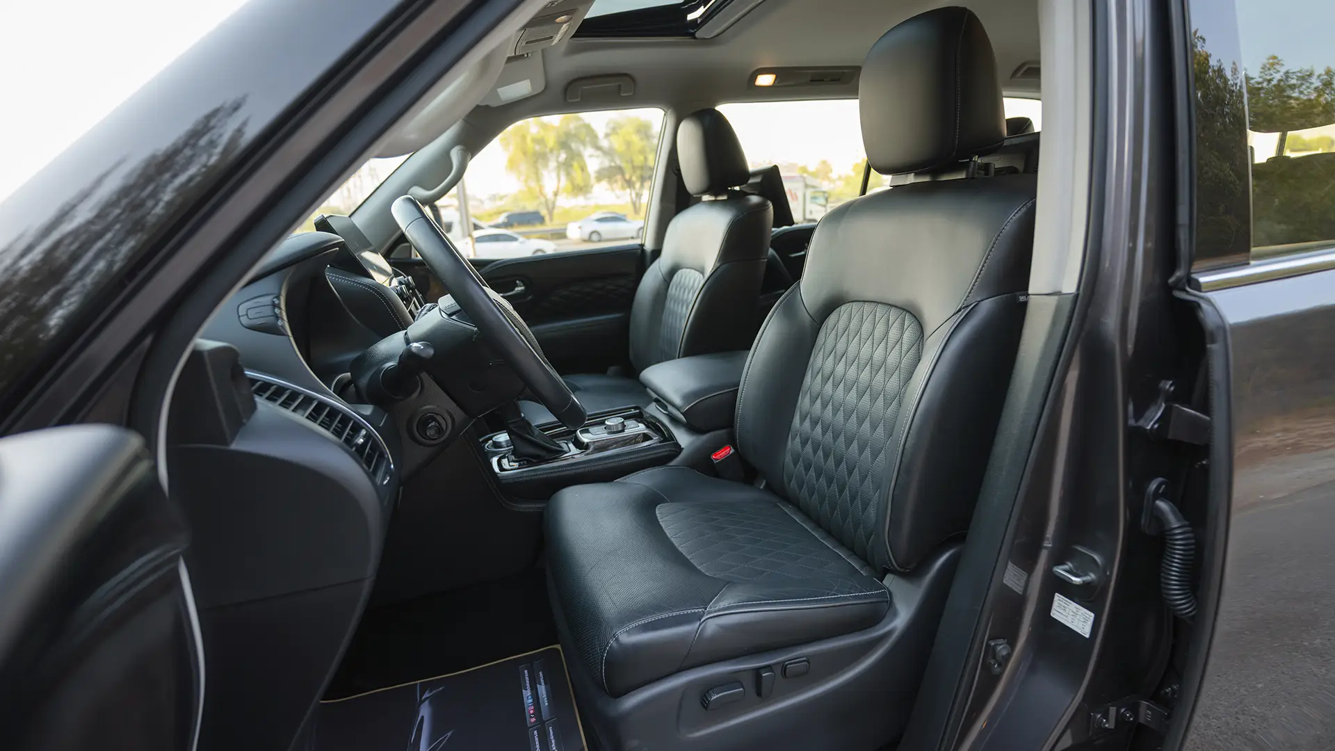 Used 2023 Infiniti QX80 Sensory in Grey – Front Driver Side Cabin View for Sale at First Choice Cars Dubai Sharjah