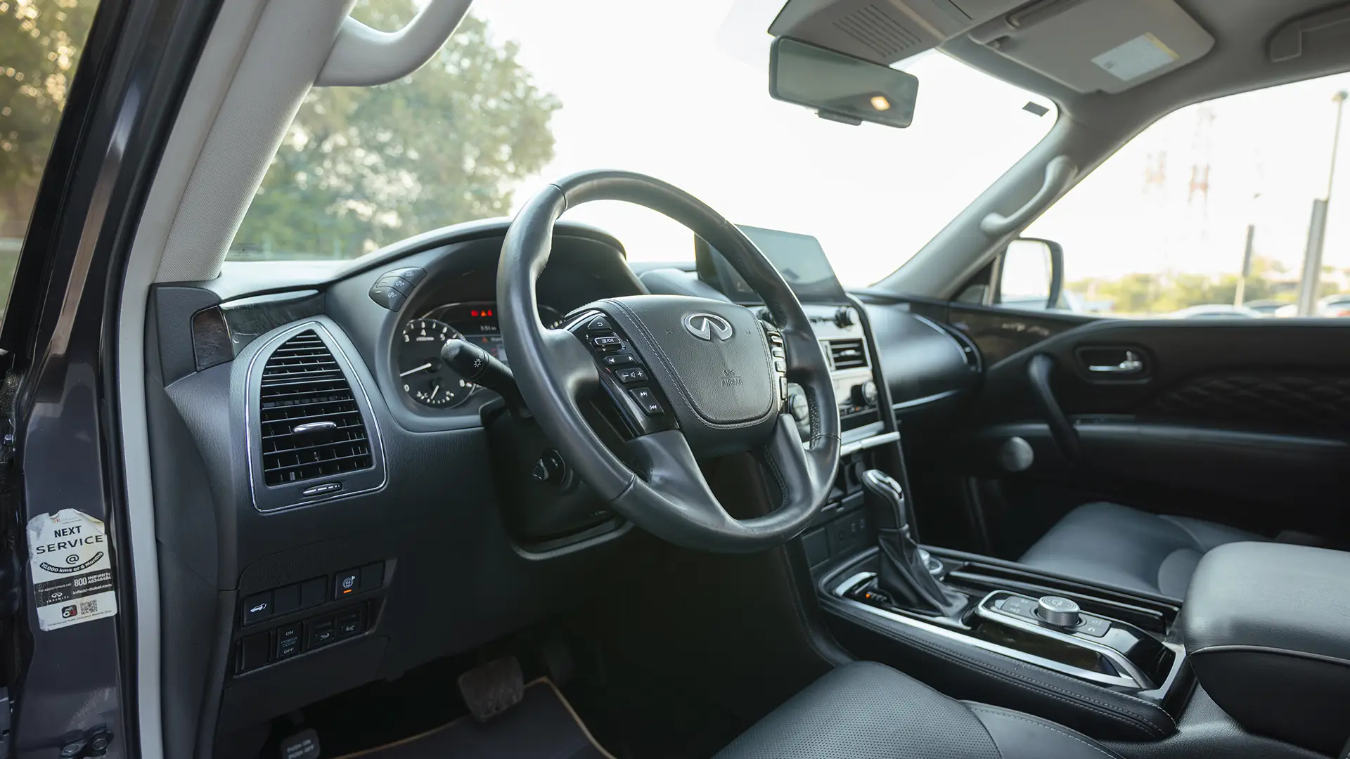 Used 2023 Infiniti QX80 Sensory in Grey – Driver Side Dashboard & Steering View for Sale at First Choice Cars Dubai Sharjah