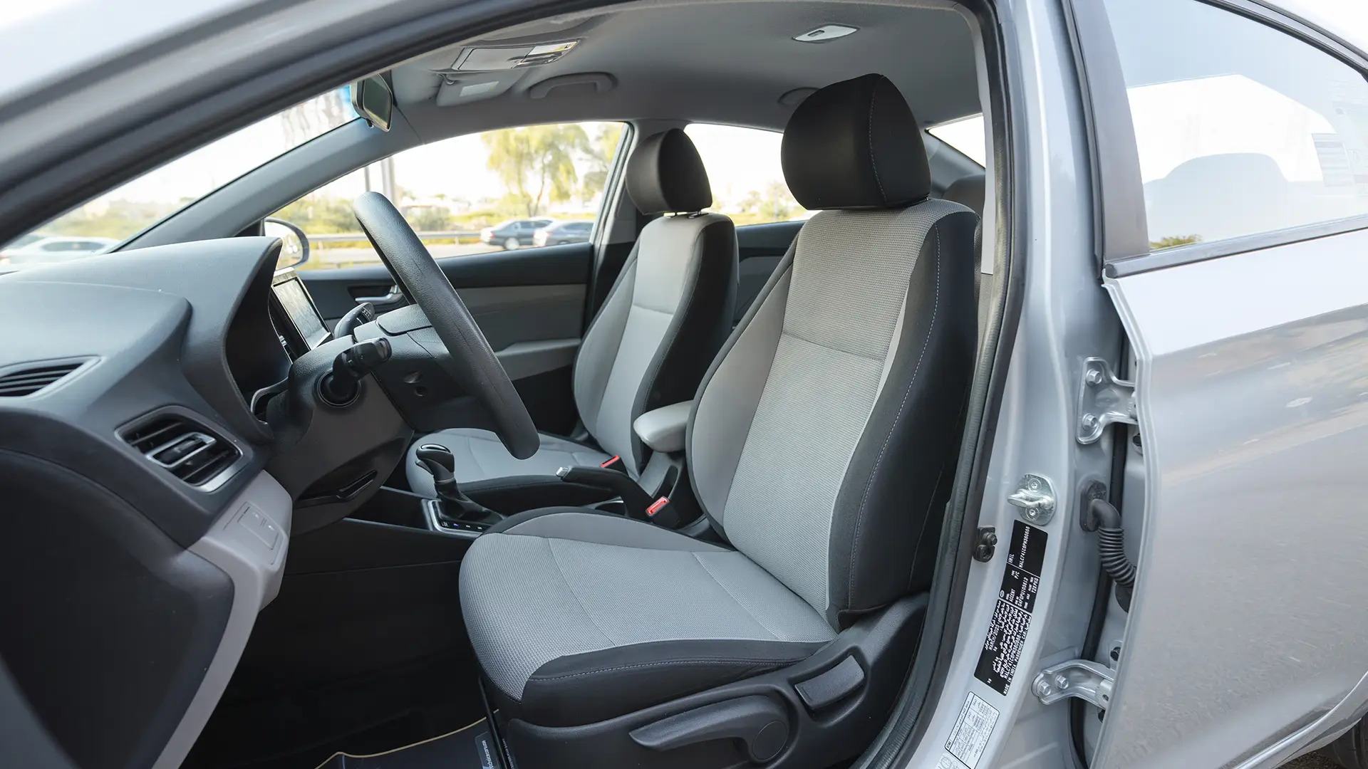 Used 2023 Hyundai Accent Smart in Silver – Front Driver Side Cabin View for Sale at First Choice Cars Dubai Sharjah