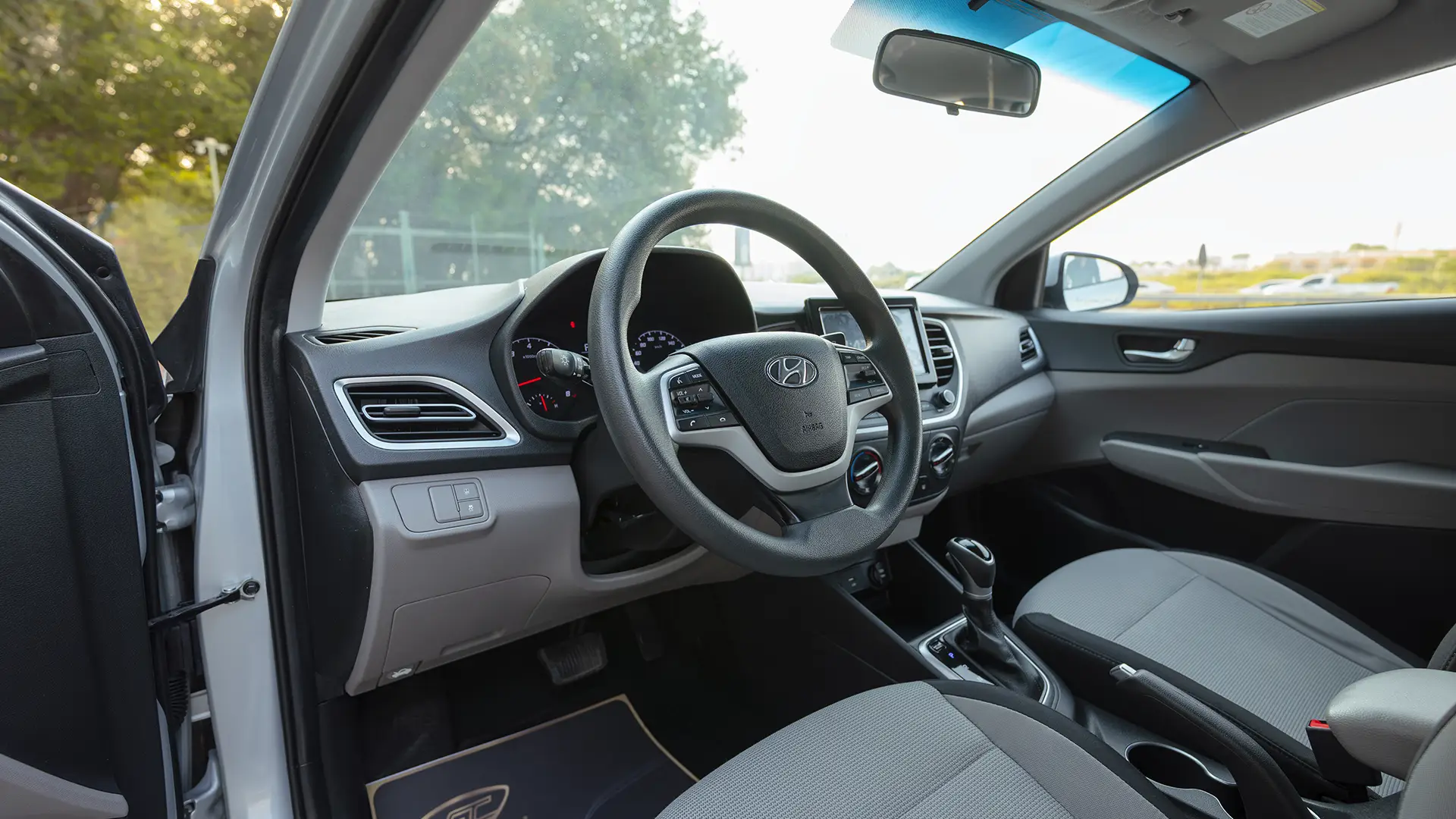 Used 2023 Hyundai Accent Smart in Silver – Driver Side Dashboard & Steering View for Sale at First Choice Cars Dubai Sharjah