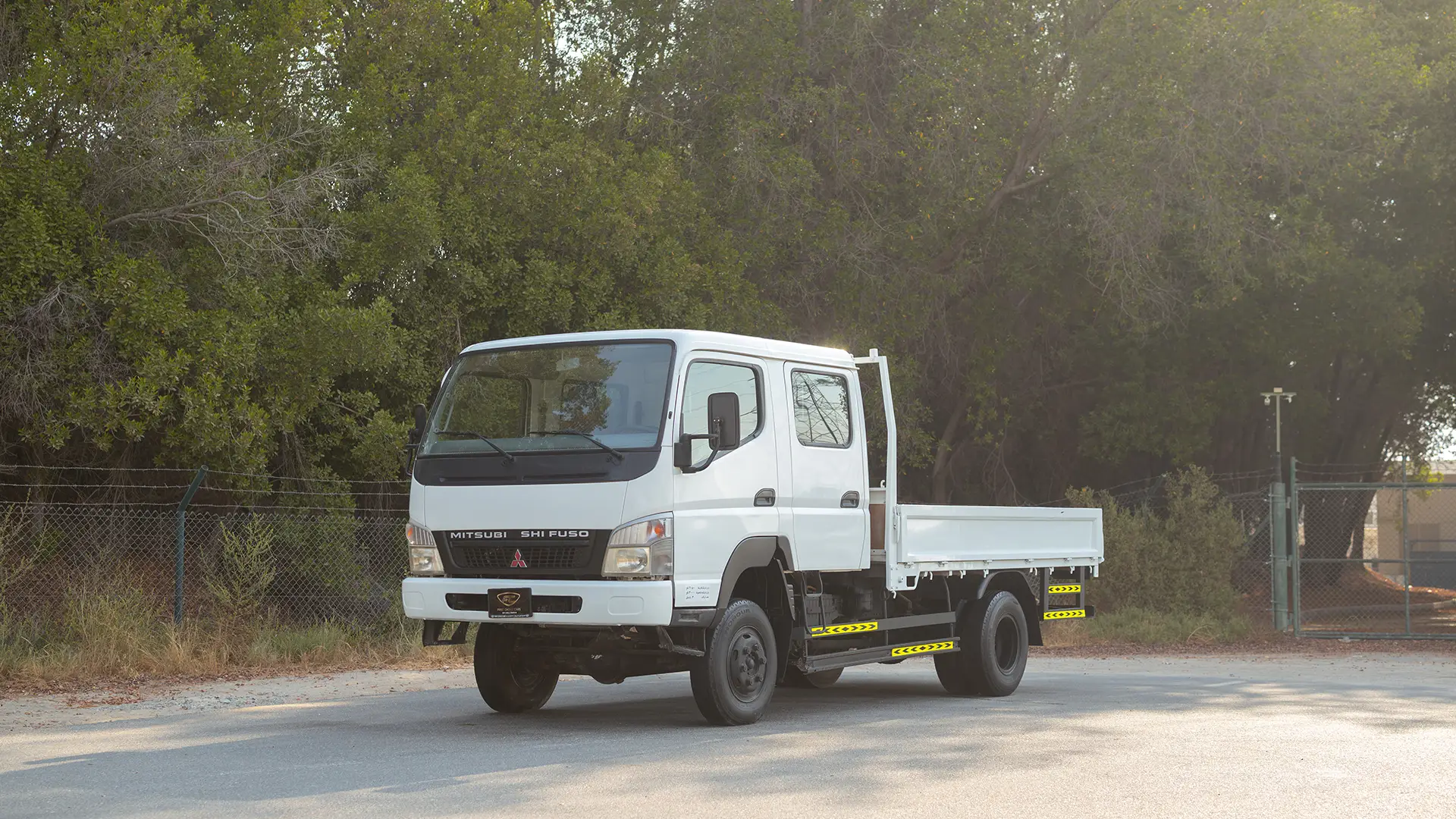 Used 2016 Mitsubishi Canter Double Cabin Cargo Body in White – Left Front Diagonal (45°) View for Sale at First Choice Cars Dubai Sharjah