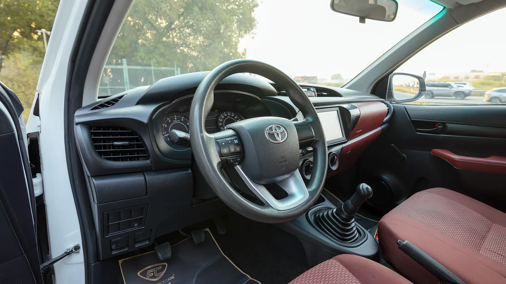 Used 2022 Toyota Hilux GLX Double Cabin in White – Driver Side Dashboard & Steering View for Sale at First Choice Cars Dubai Sharjah