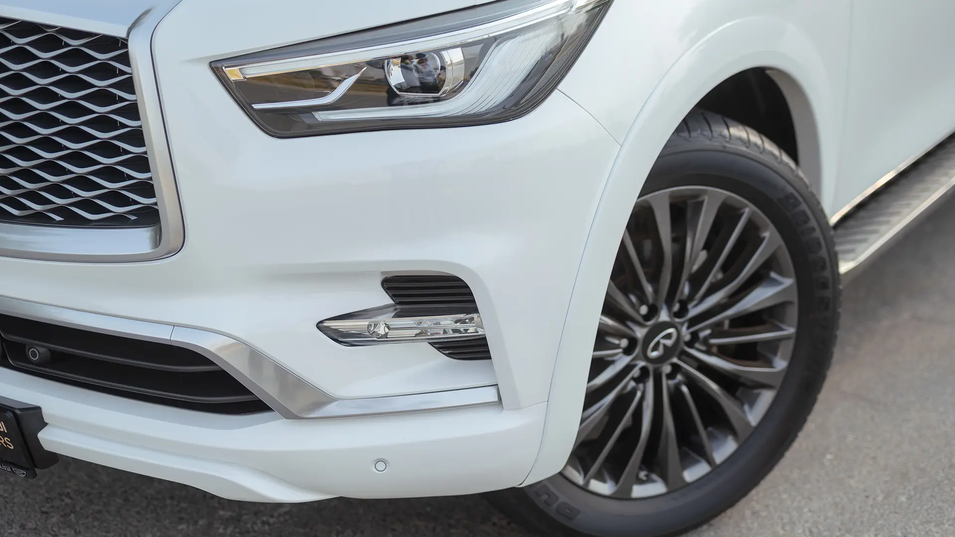 Used 2024 Infiniti QX80 Sensory in White – Headlight Close-up for Sale at First Choice Cars Dubai Sharjah