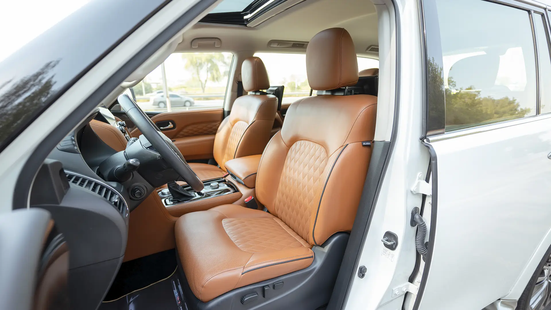 Used 2024 Infiniti QX80 Sensory in White – Front Driver Side Cabin View for Sale at First Choice Cars Dubai Sharjah