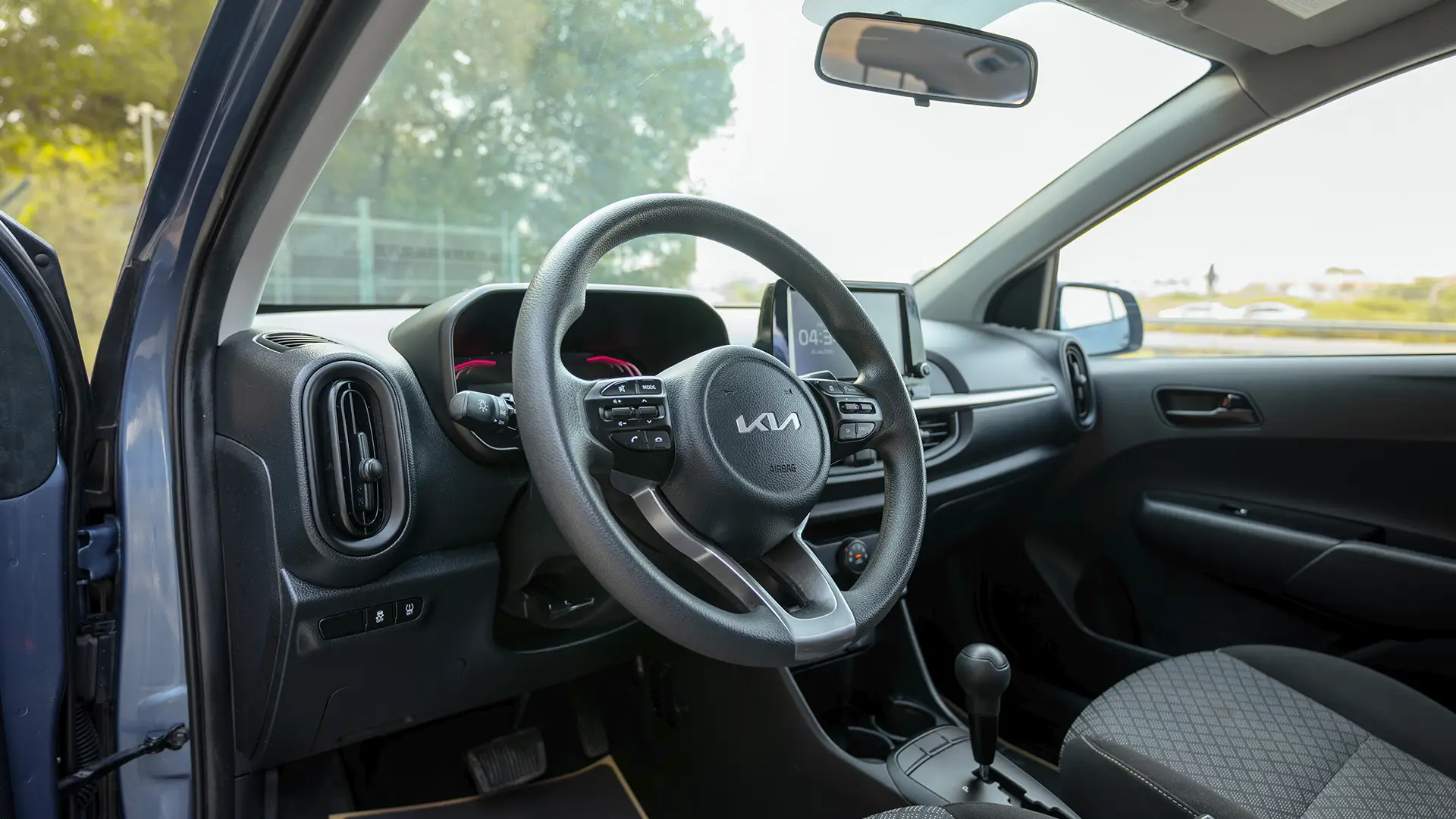 Used 2024 Kia Picanto LX in Blue – Driver Side Dashboard & Steering View for Sale at First Choice Cars Dubai Sharjah