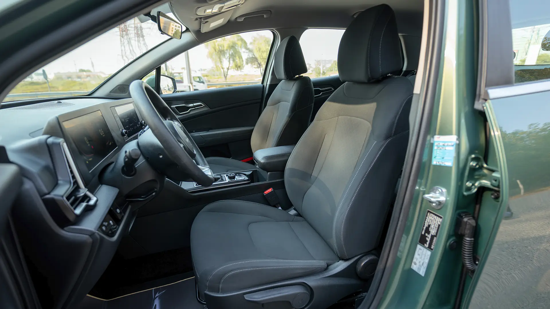Used 2025 Kia Sportage LX in Green – Front Driver Side Cabin View for Sale at First Choice Cars Dubai Sharjah