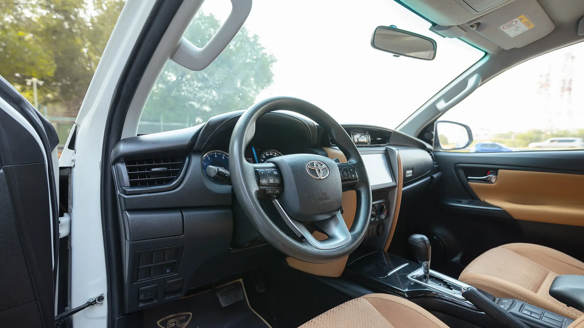 Used 2021 Toyota Fortuner EXR in White – Driver Side Dashboard & Steering View for Sale at First Choice Cars Dubai Sharjah