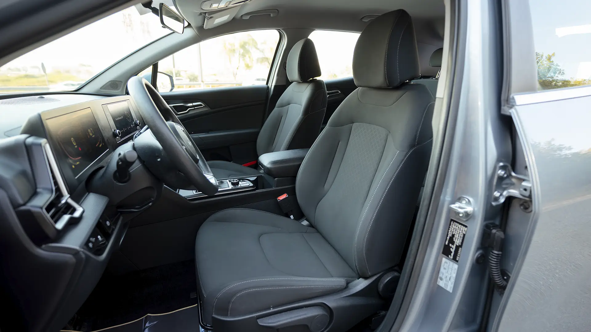 Used 2025 Kia Sportage LX in Silver – Front Driver Side Cabin View for Sale at First Choice Cars Dubai Sharjah