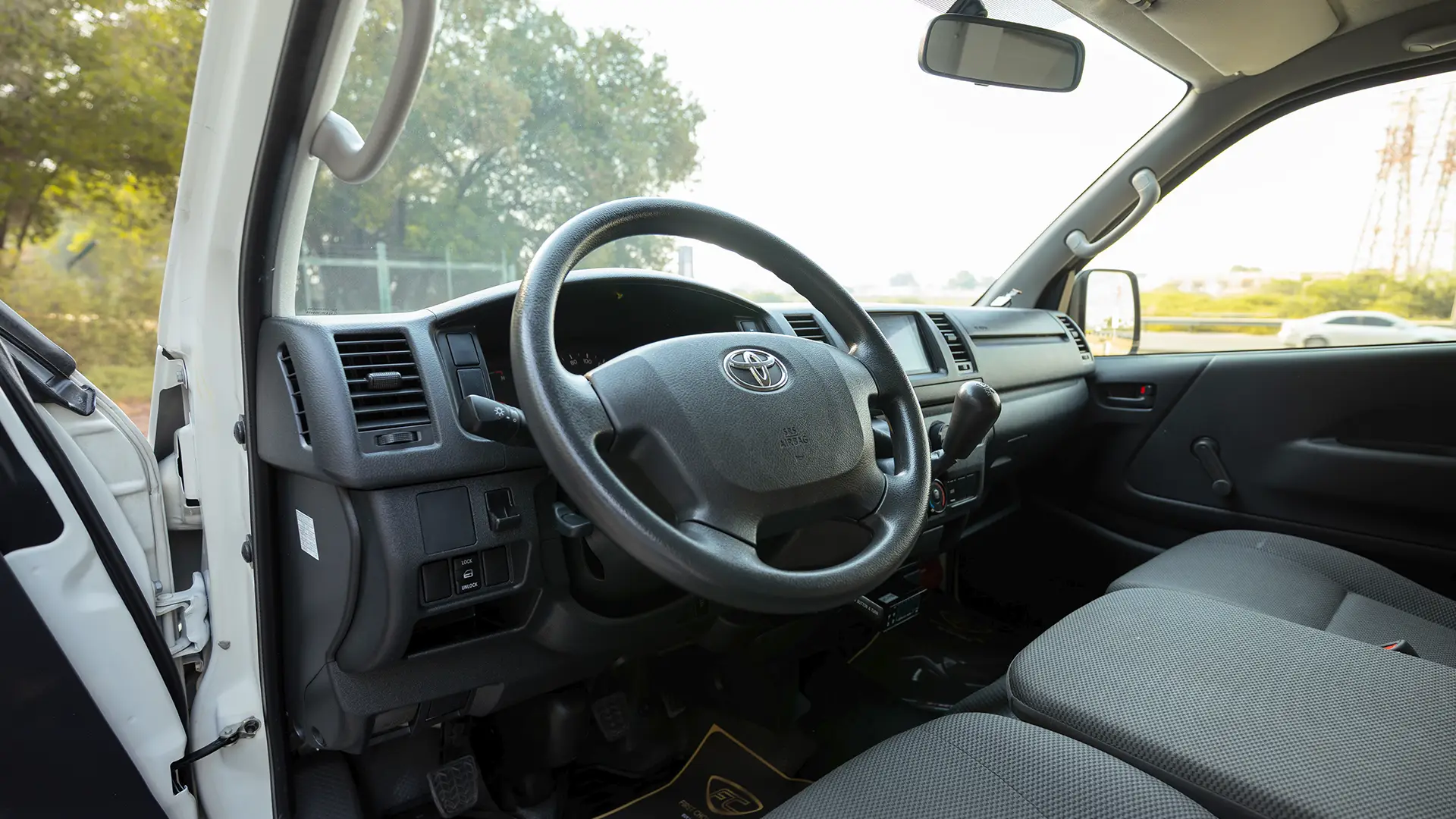 Used 2024 Toyota Hiace GL Standard Roof in White – Driver Side Dashboard & Steering View for Sale at First Choice Cars Dubai Sharjah