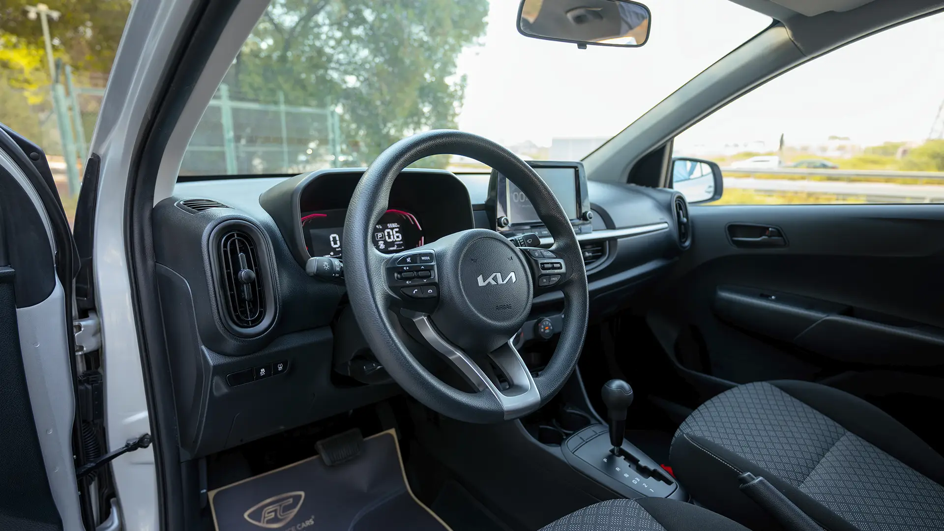 Used 2024 Kia Picanto LX in Silver – Driver Side Dashboard & Steering View for Sale at First Choice Cars Dubai Sharjah
