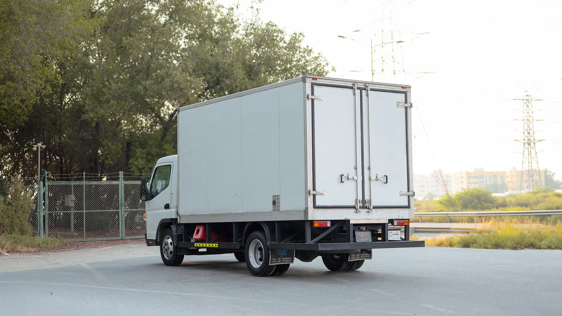 Used 2022 Mitsubishi Canter Chiller Box in White – Left Back Diagonal (45°) View for Sale at First Choice Cars Dubai Sharjah