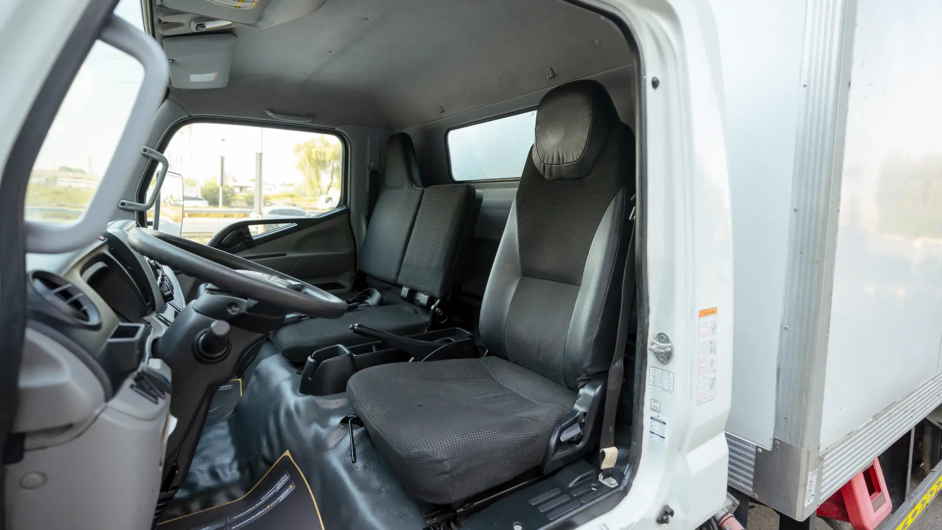 Used 2022 Mitsubishi Canter Chiller Box in White – Front Driver Side Cabin View for Sale at First Choice Cars Dubai Sharjah