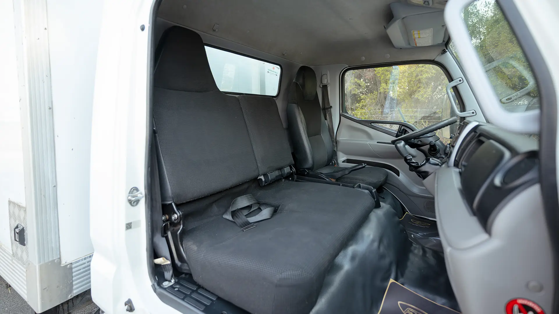 Used 2022 Mitsubishi Canter Chiller Box in White – Front Passenger Side Cabin View for Sale at First Choice Cars Dubai Sharjah