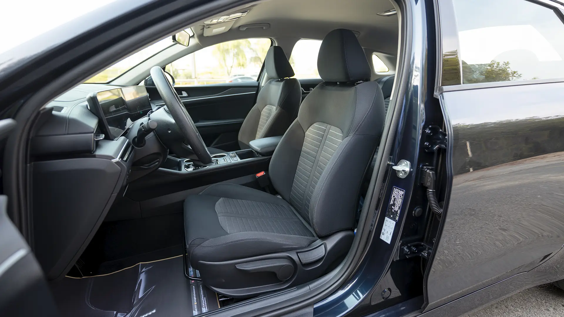 Used 2024 Kia K5 LX in White – Front Driver Side Cabin View for Sale at First Choice Cars Dubai Sharjah