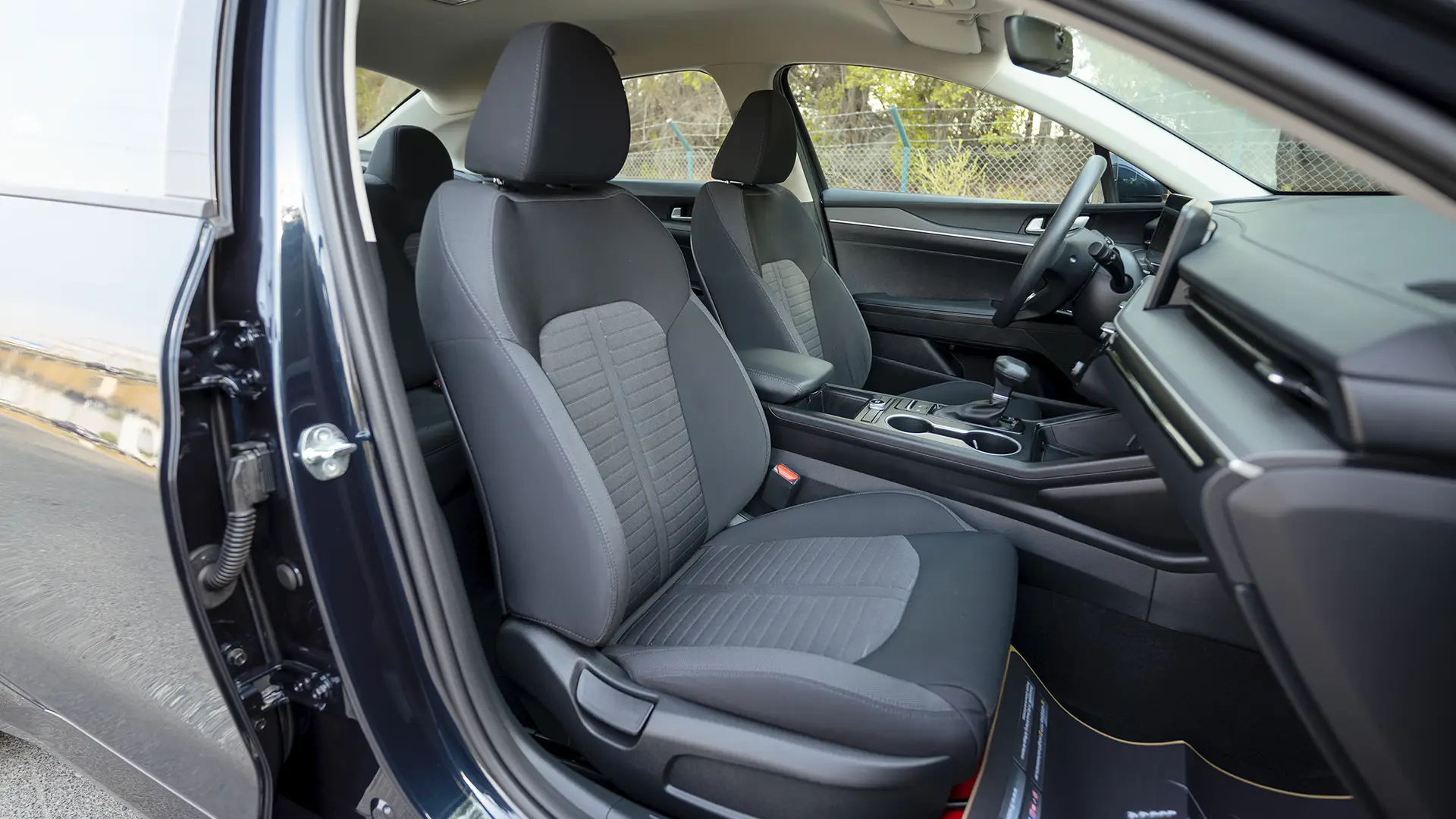 Used 2024 Kia K5 LX in White – Front Passenger Side Cabin View for Sale at First Choice Cars Dubai Sharjah