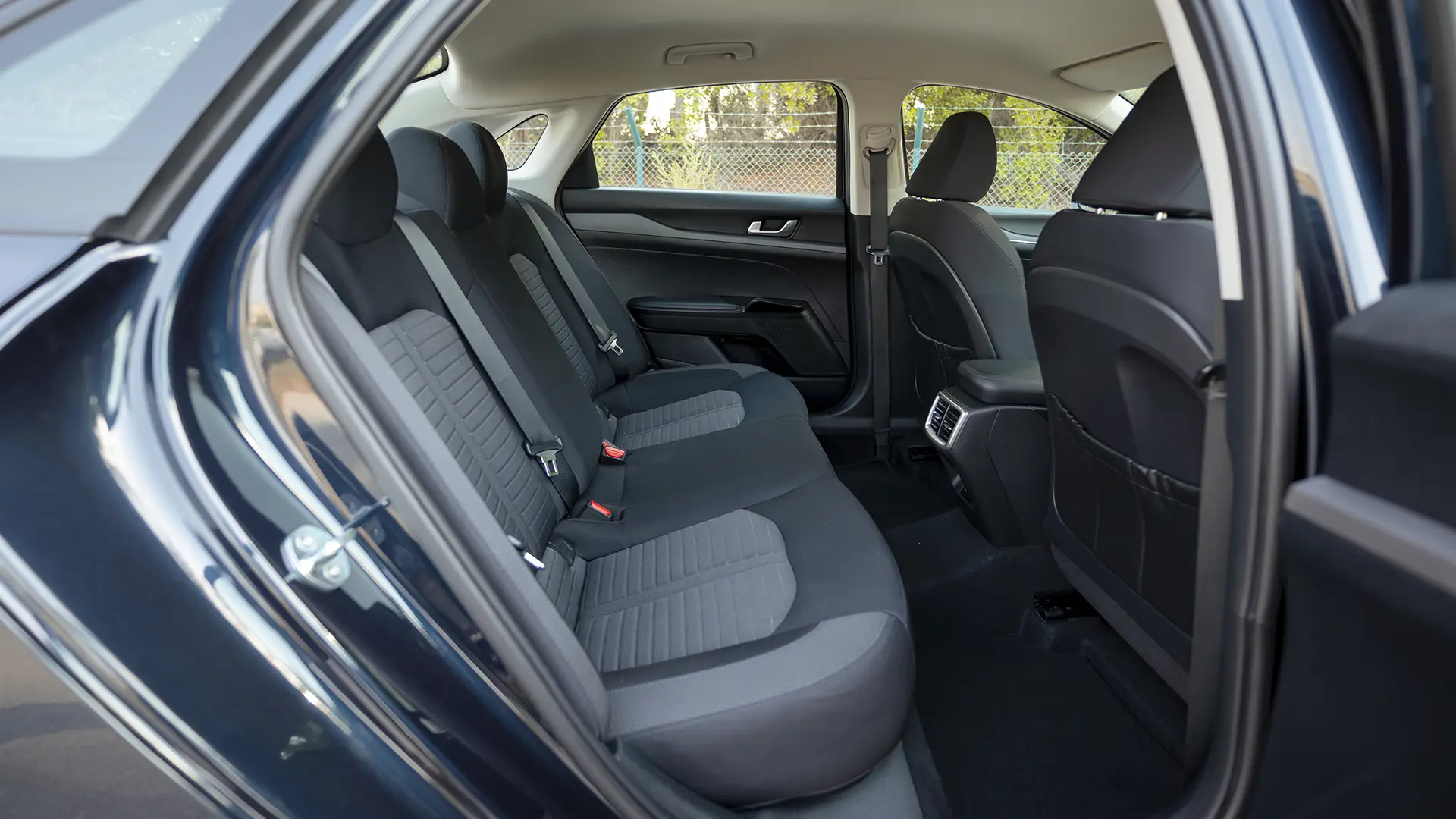 Used 2024 Kia K5 LX in White – Rear Passenger Side Cabin View for Sale at First Choice Cars Dubai Sharjah