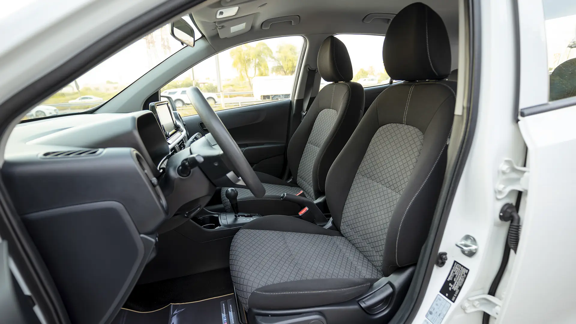 Used 2024 Kia Picanto LX in White – Front Driver Side Cabin View for Sale at First Choice Cars Dubai Sharjah