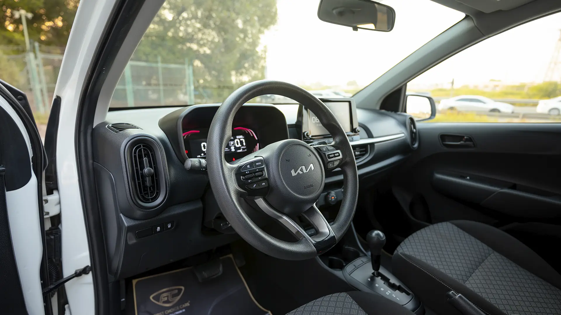 Used 2024 Kia Picanto LX in White – Driver Side Dashboard & Steering View for Sale at First Choice Cars Dubai Sharjah