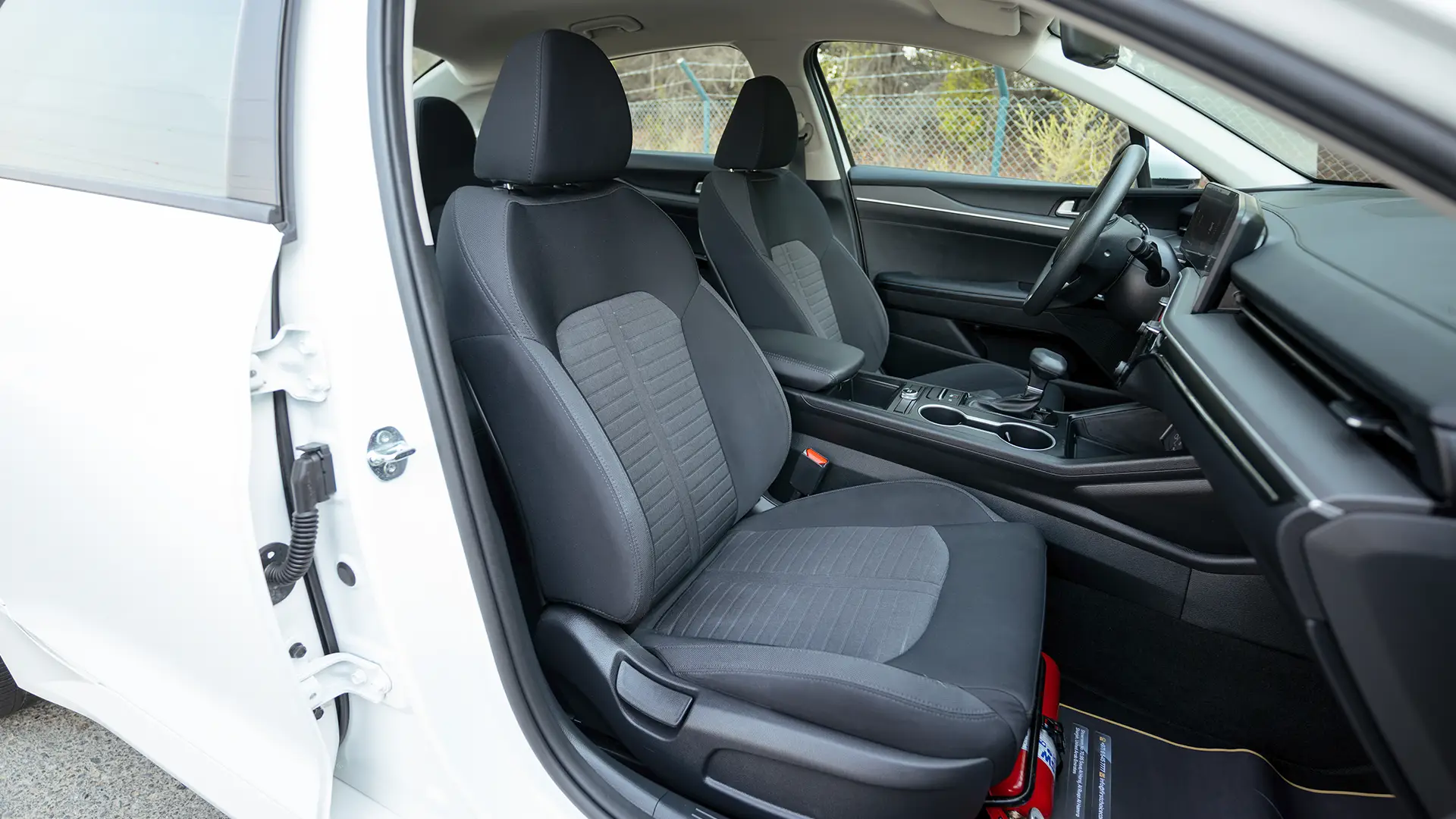 Used 2024 Kia K5 LX in White – Front Passenger Side Cabin View for Sale at First Choice Cars Dubai Sharjah