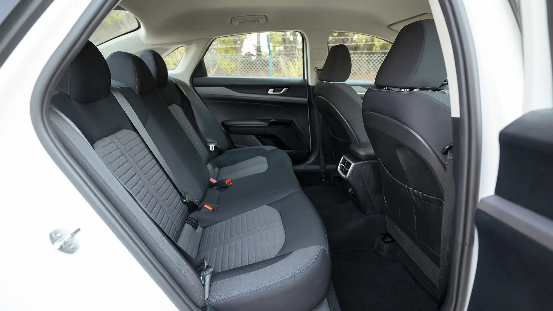 Used 2024 Kia K5 LX in White – Rear Passenger Side Cabin View for Sale at First Choice Cars Dubai Sharjah