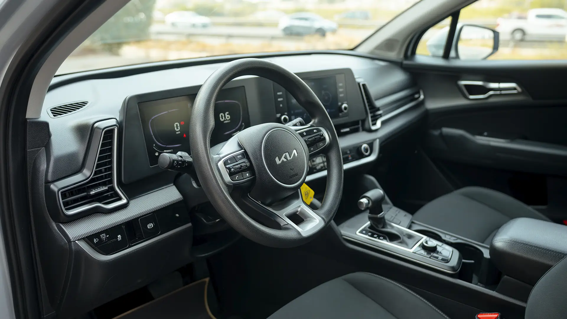 Used 2023 Kia Sportage LX in Silver – Driver Side Dashboard & Steering View for Sale at First Choice Cars Dubai Sharjah