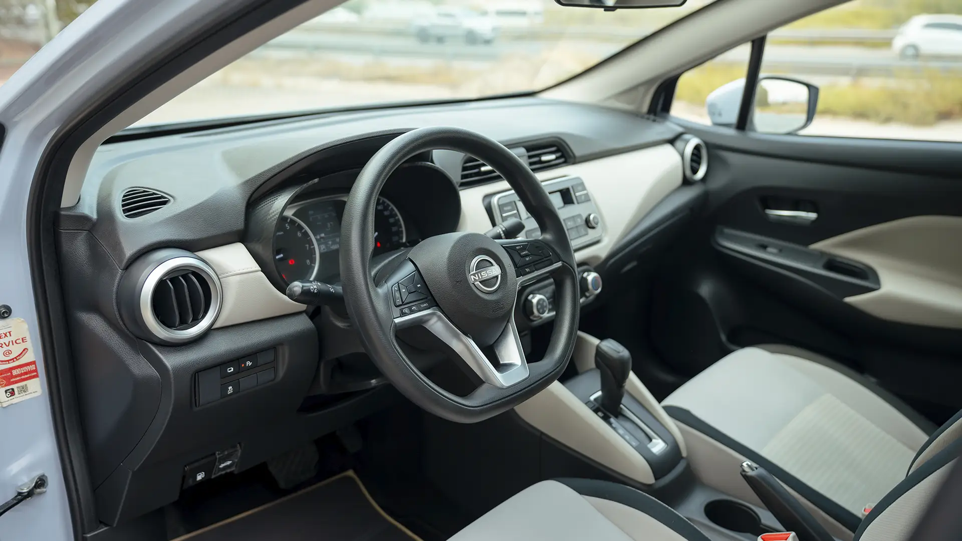 Used 2024 Nissan Sunny S in Grey – Driver Side Dashboard & Steering View for Sale at First Choice Cars Dubai Sharjah