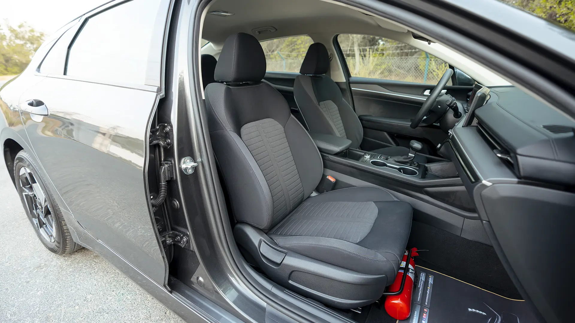 Used 2024 Kia K5 LX in Grey – Front Passenger Side Cabin View for Sale at First Choice Cars Dubai Sharjah