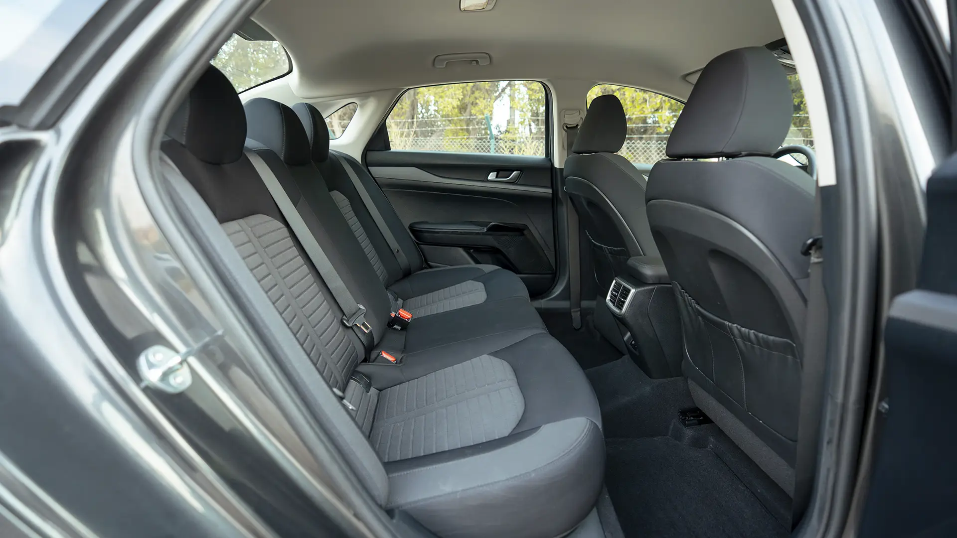 Used 2024 Kia K5 LX in Grey – Rear Passenger Side Cabin View for Sale at First Choice Cars Dubai Sharjah