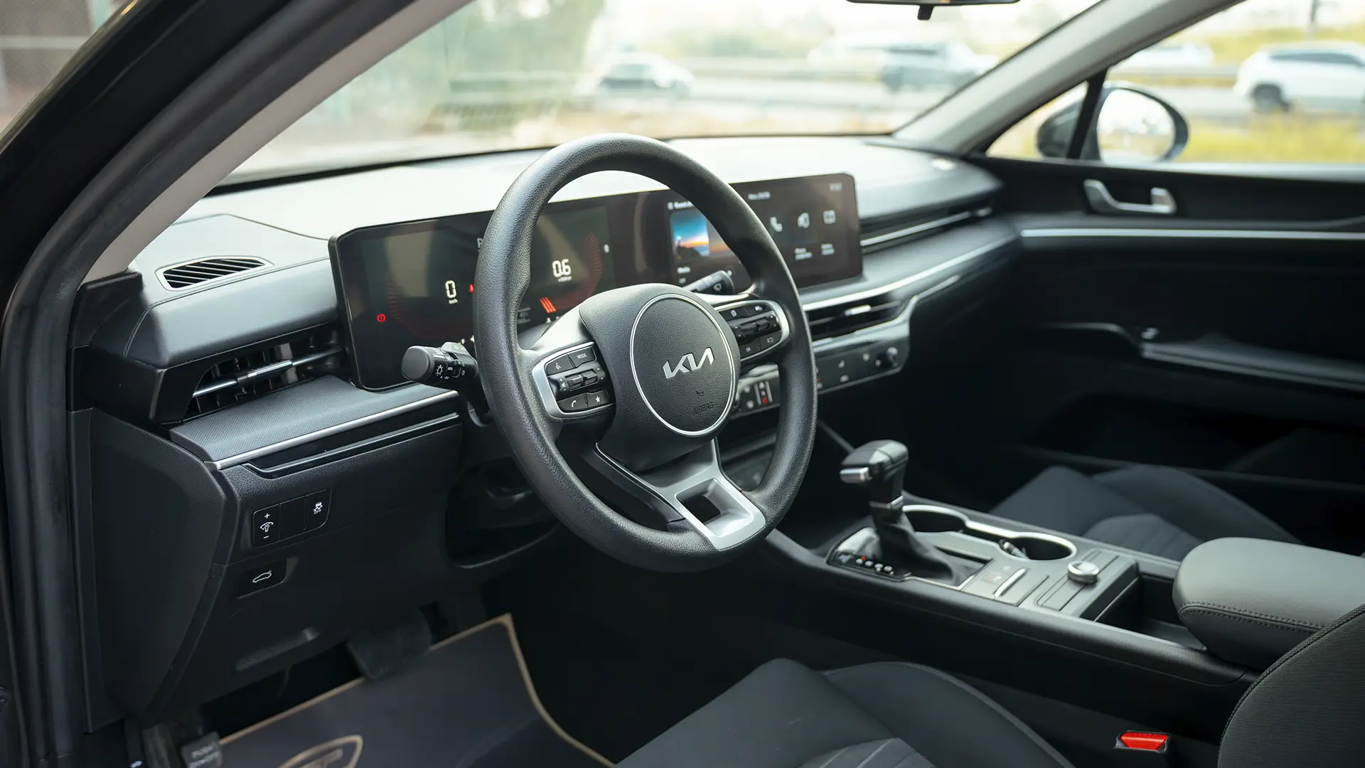 Used 2024 Kia K5 LX in Grey – Driver Side Dashboard & Steering View for Sale at First Choice Cars Dubai Sharjah