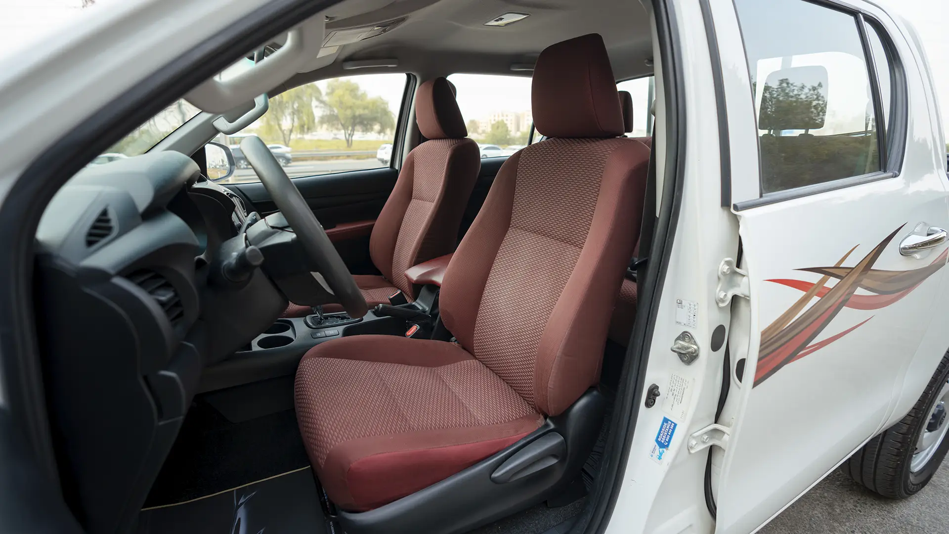 Used 2022 Toyota Hilux GLX Double Cabin in White – Front Driver Side Cabin View for Sale at First Choice Cars Dubai Sharjah