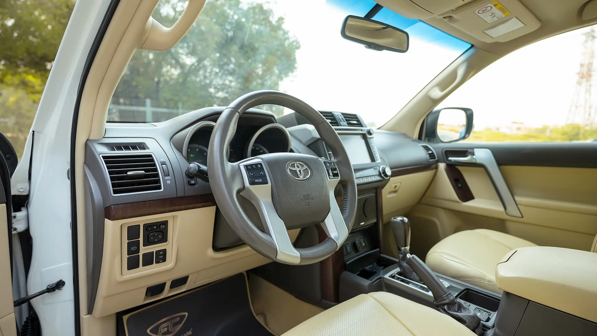 Used 2016 Toyota Prado VXR in White – Driver Side Dashboard & Steering View for Sale at First Choice Cars Dubai Sharjah