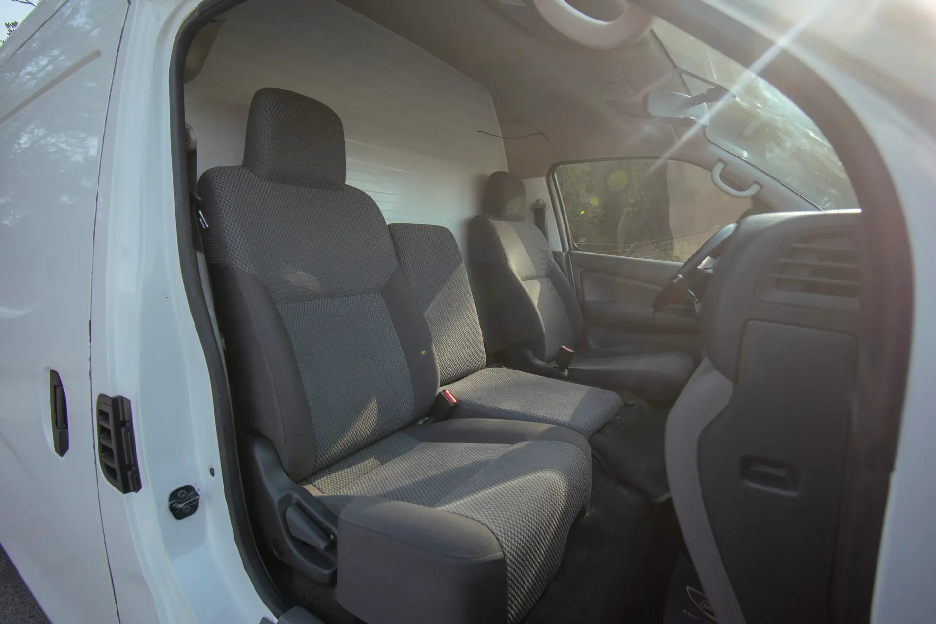 Used 2022 Nissan Urvan High Roof in White – Front Passenger Side Cabin View for Sale at First Choice Cars Dubai Sharjah