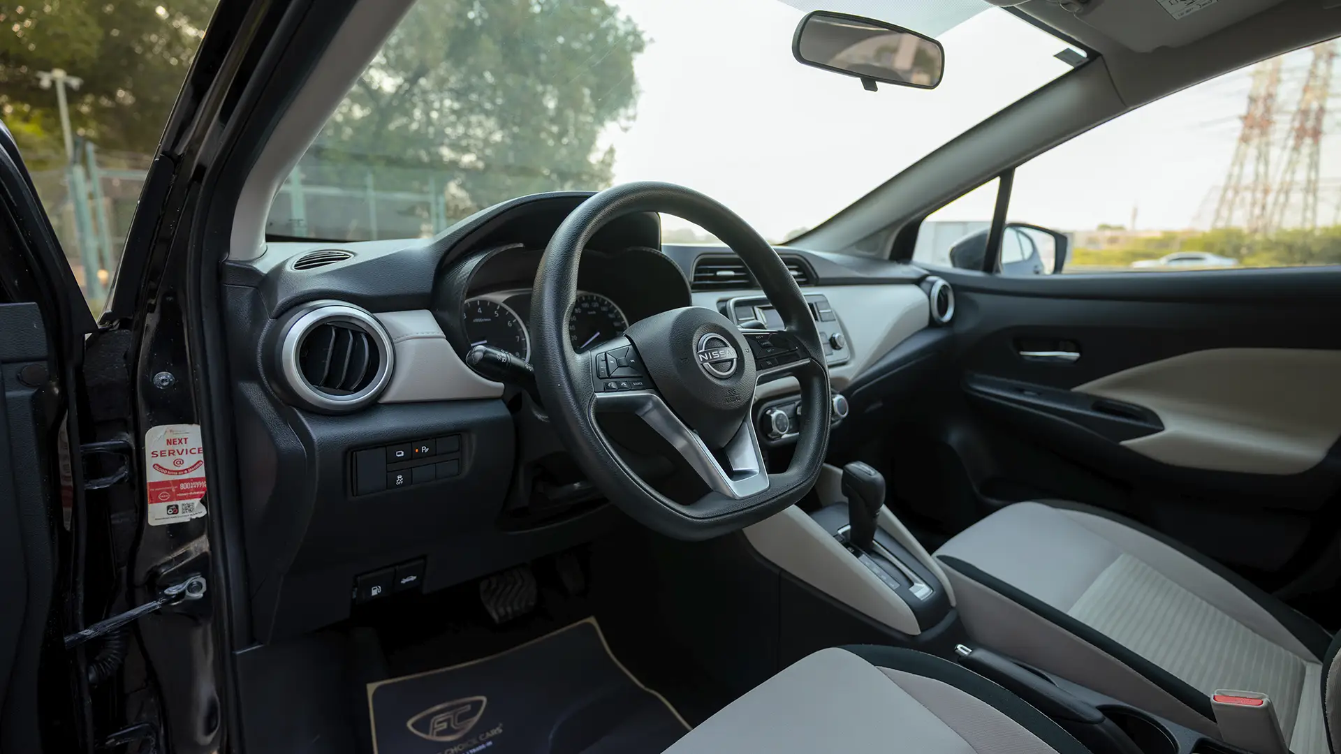 Used 2024 Nissan Sunny S in Black – Driver Side Dashboard & Steering View for Sale at First Choice Cars Dubai Sharjah