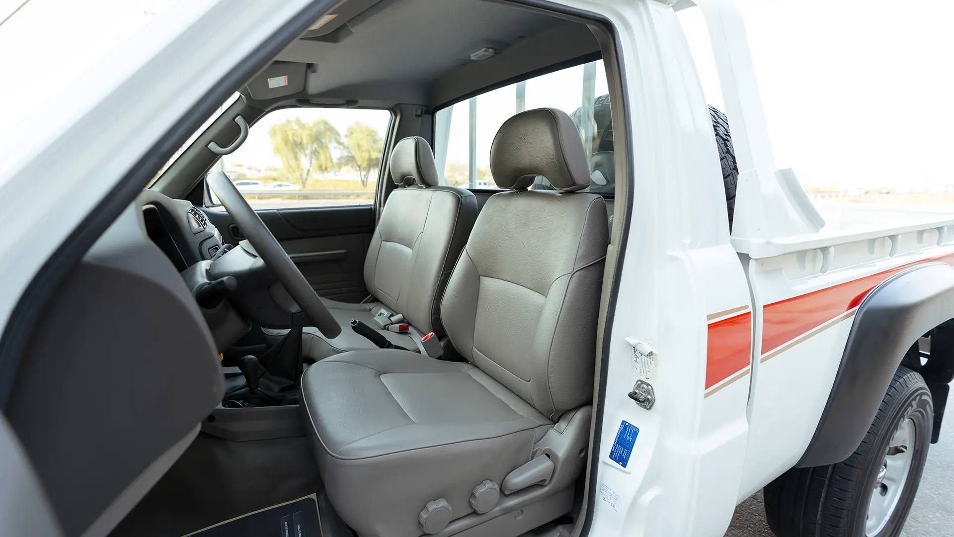 Used 2022 Nissan Patrol Pickup GL in White – Front Driver Side Cabin View for Sale at First Choice Cars Dubai Sharjah