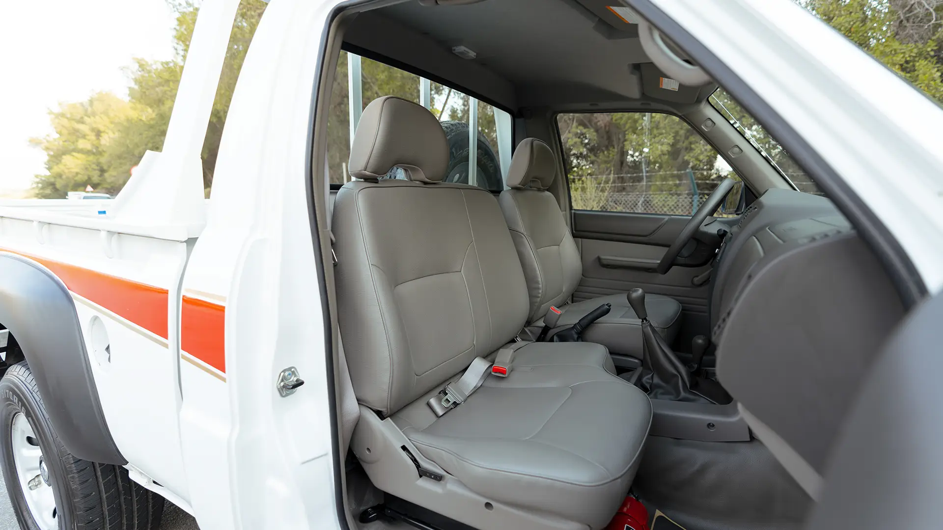 Used 2022 Nissan Patrol Pickup GL in White – Front Passenger Side Cabin View for Sale at First Choice Cars Dubai Sharjah