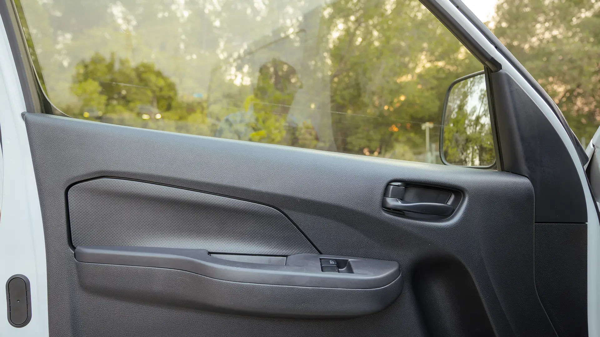 Used 2023 Nissan Urvan Standard Roof in White – Driver Door Panel Full View for Sale at First Choice Cars Dubai Sharjah