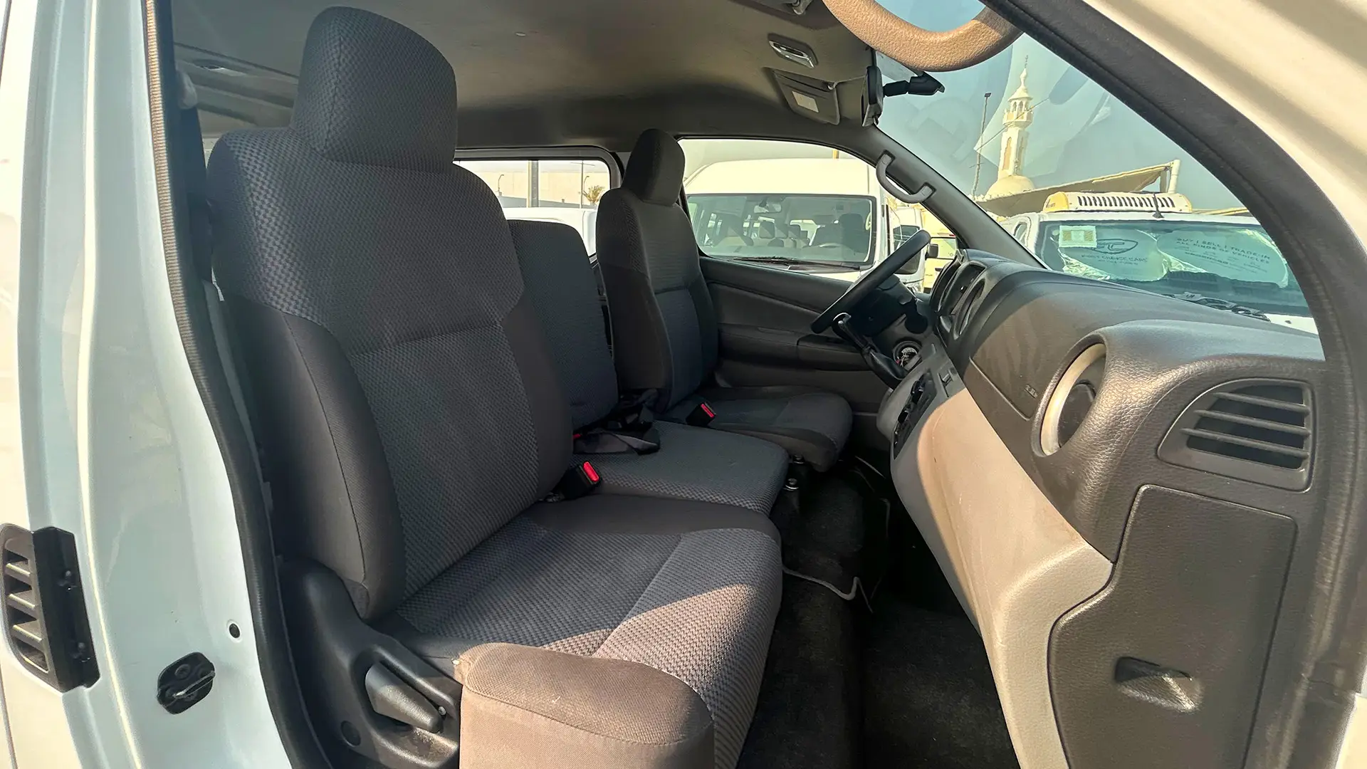 Used 2022 Nissan Urvan Standard Roof in White – Front Passenger Side Cabin View for Sale at First Choice Cars Dubai Sharjah