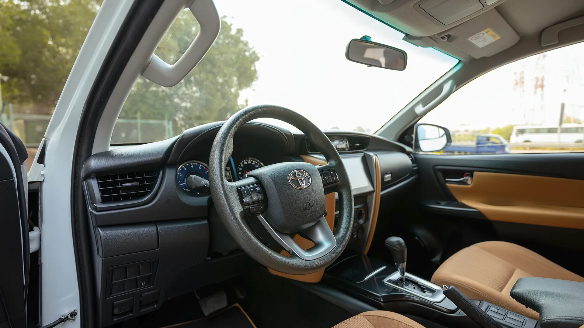 Used 2025 Toyota Fortuner EXR in White – Driver Side Dashboard & Steering View for Sale at First Choice Cars Dubai Sharjah