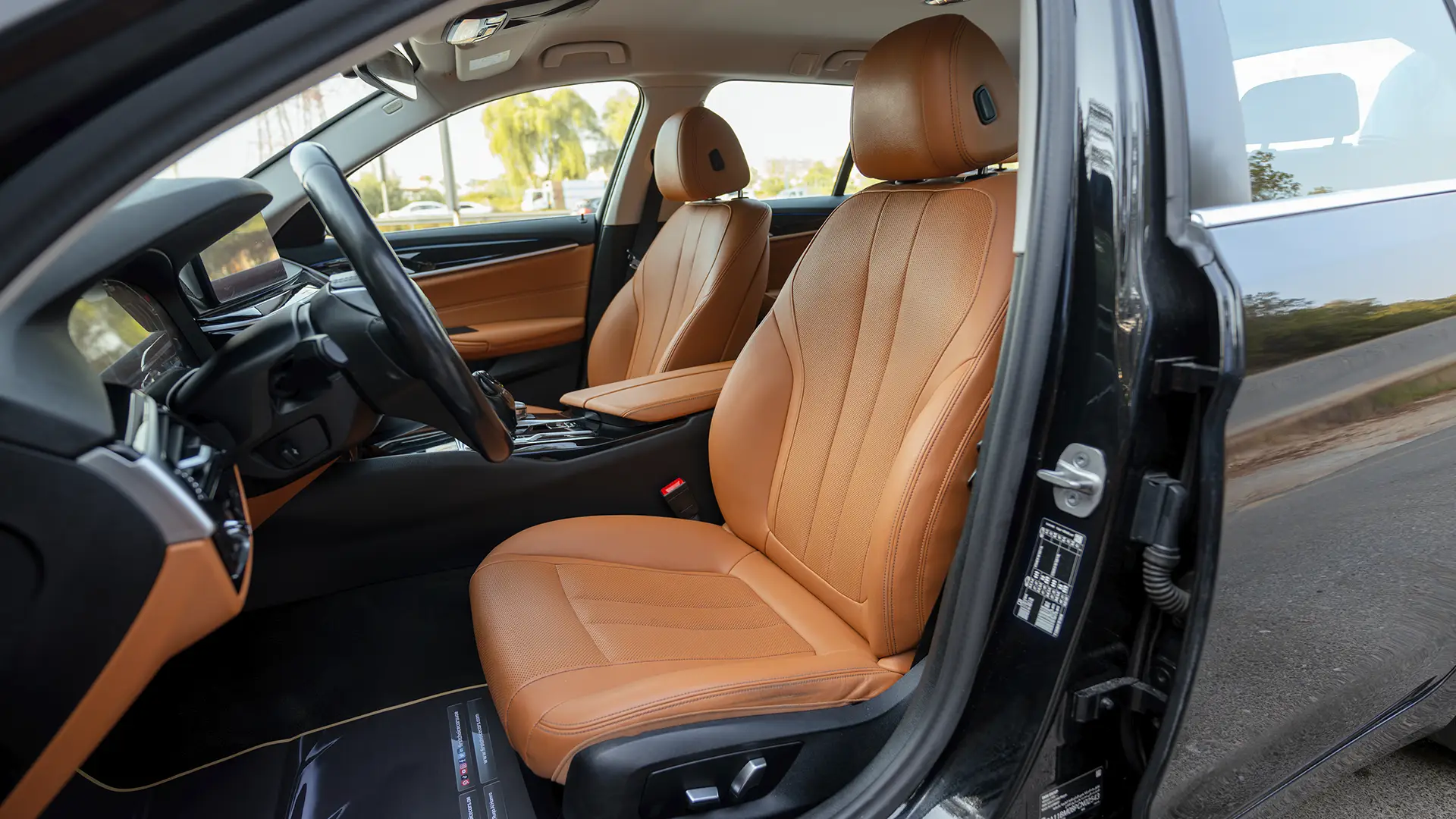 Used 2023 BMW 5-Series 520i in Black – Front Driver Side Cabin View for Sale at First Choice Cars Dubai Sharjah