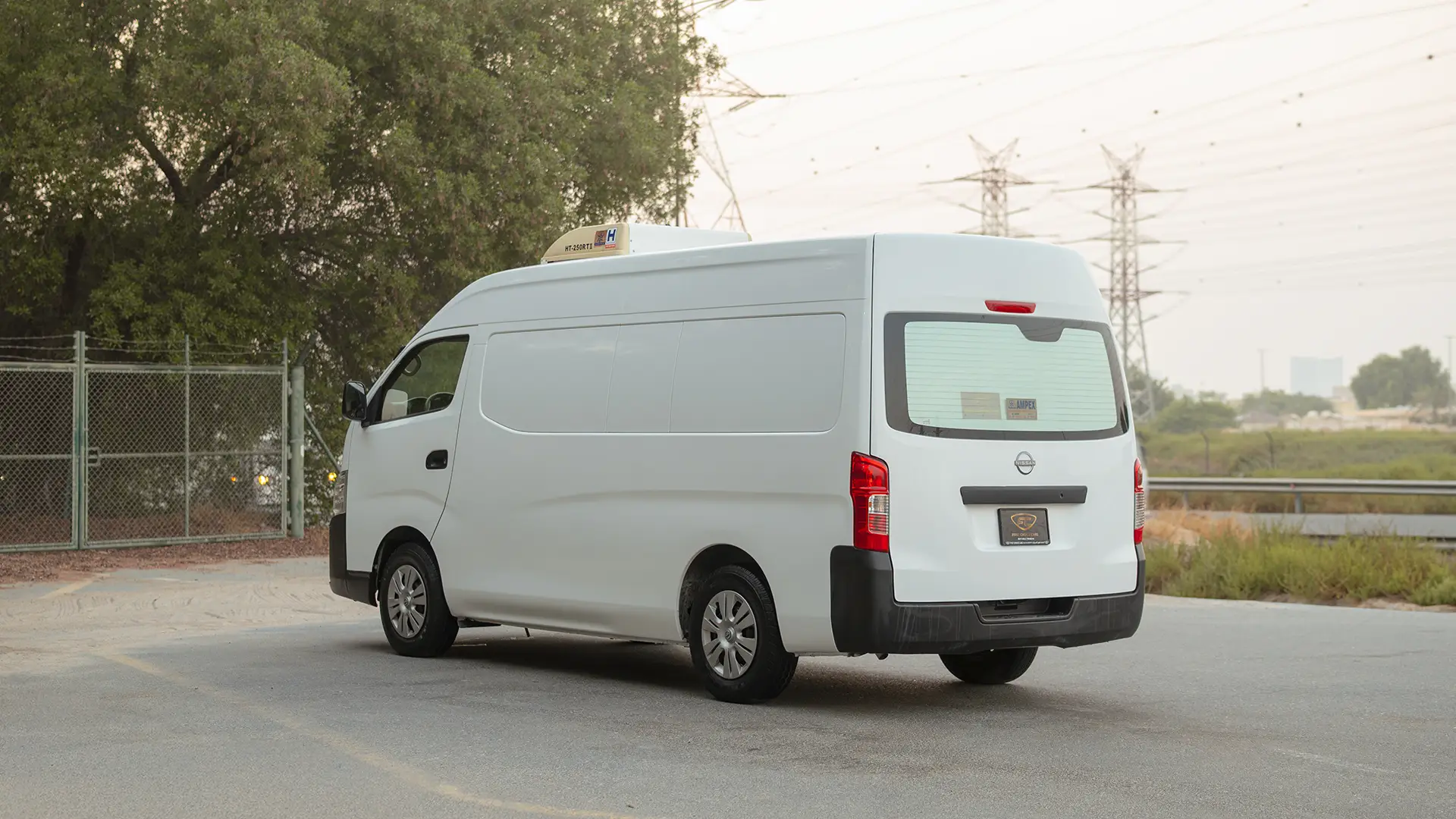 Used 2023 Nissan Urvan High Roof in White – Left Back Diagonal (45°) View for Sale at First Choice Cars Dubai Sharjah