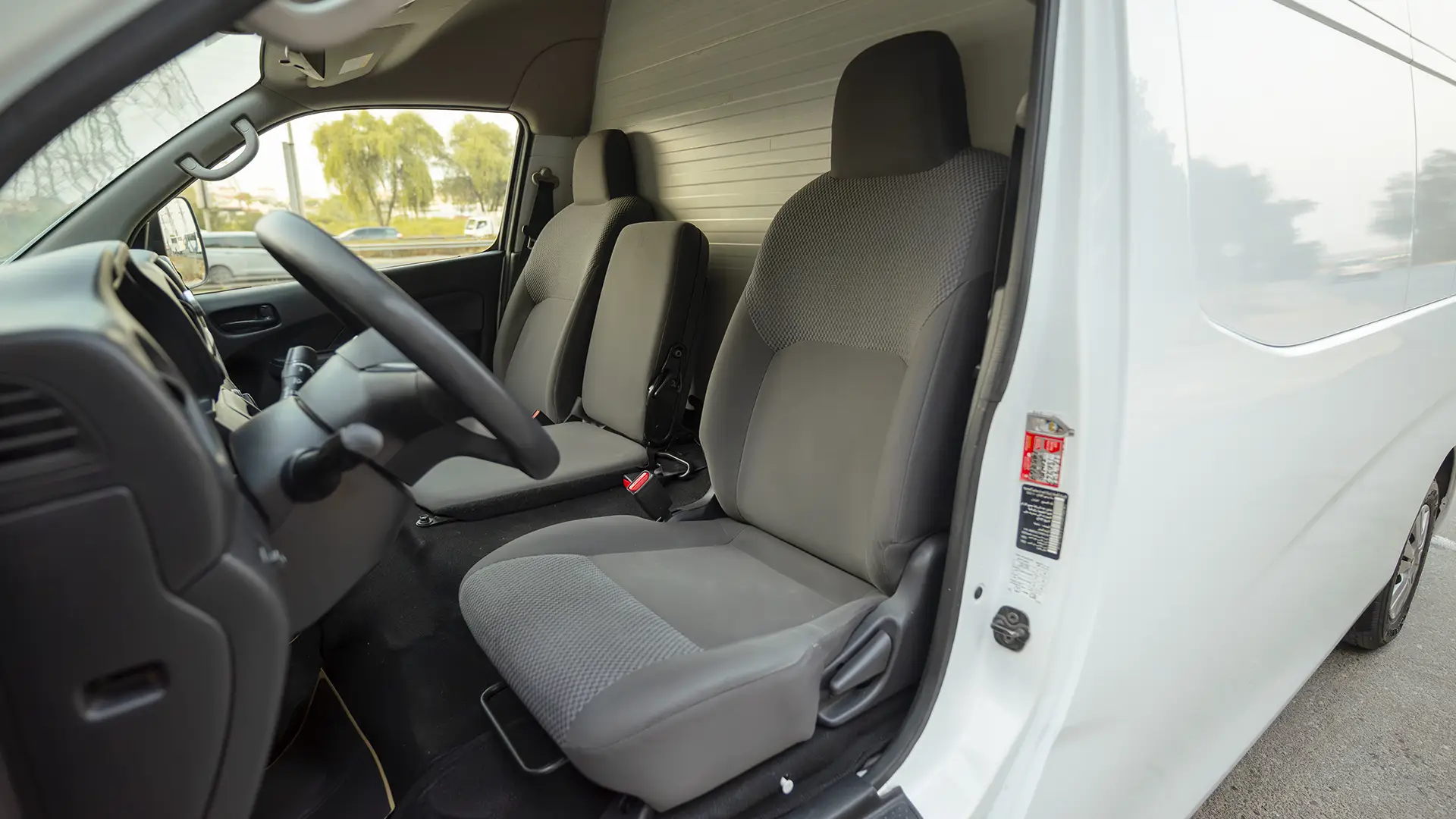 Used 2023 Nissan Urvan High Roof in White – Front Driver Side Cabin View for Sale at First Choice Cars Dubai Sharjah